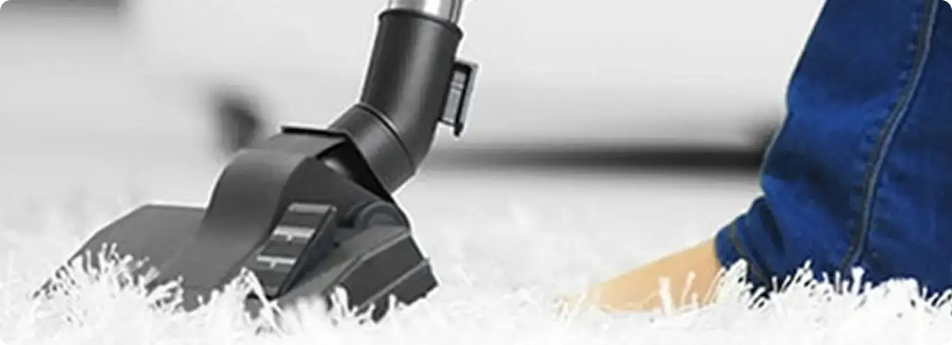 Close-up of a professional vacuuming a white carpet in Apache Junction.